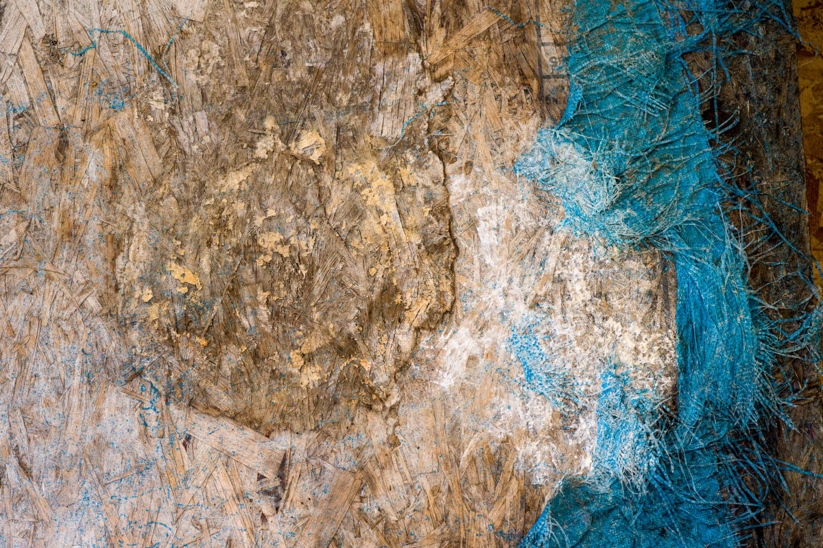 Beauty and abstraction can be found in the simplest of objects.  In this case, a piece of molded OSB construction board and a rotted tarp.
