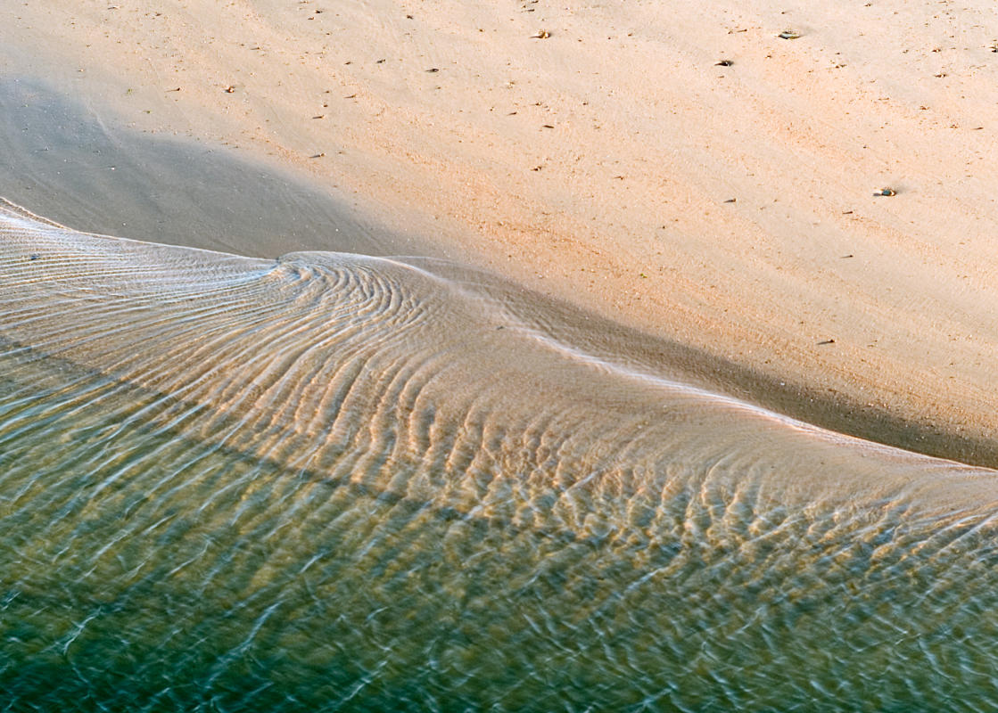 This image of the North Sea lapping at the shore near St. Andrews in Scotland is one of my favorite photographs because of the simplicity, the texture and the contrast of the mystical.  Just a simple beach at the edge of the sea, on a planet at the edge of a modest galaxy, part of an unfathonably vast universe.  These two extremes of the infinitesimally large and the small world of our consciousness, to the infinitesimally small quantum world continually fascinate and astound me.  Photographs are a metaphor for this dichotomy since they capture an instant of time within the infinity of time.
